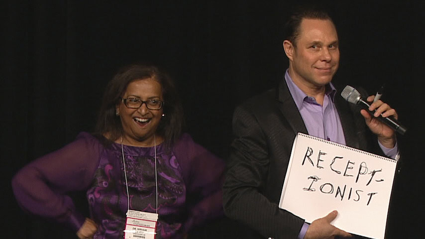 Randy, magician and mentalist performing on stage.