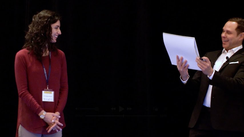 Randy Charach corporate magician performing on stage.
