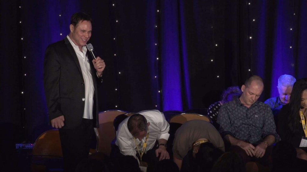 Audience reacting to Magician, Randy Charach, performance on stage.