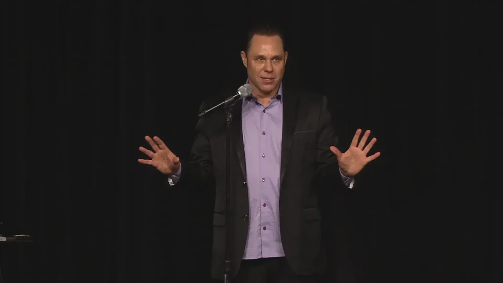 Randy, speaking, with confidence on stage